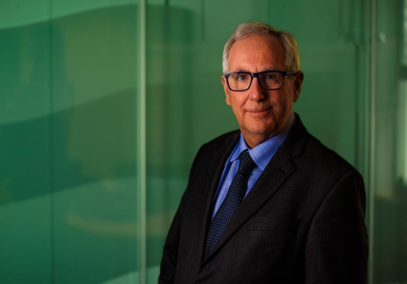 A professional headshot of George Ritchie